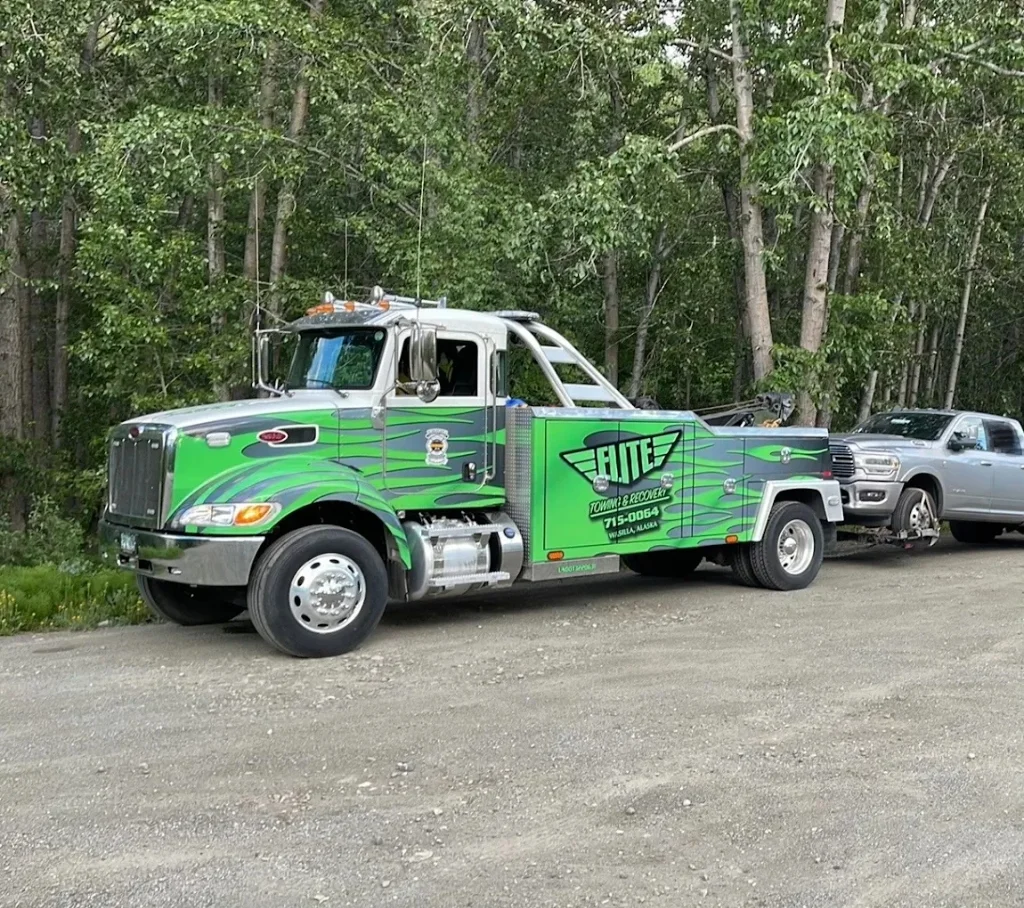 Elite Towing custom lime green Peterbilt flatbed tow truck side view (Real Photo)