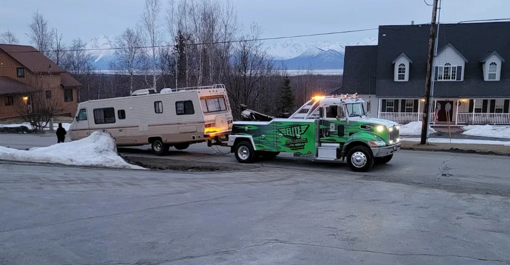 Elite Towing Peterbilt flatbed towing a vintage motorhome RV (Real Photo)